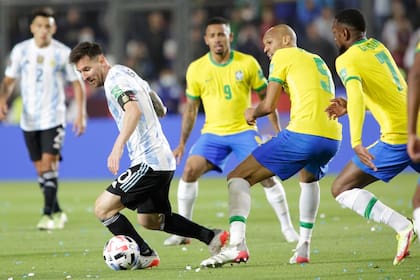 Messi y la pelota, vigilado por los volantes brasileños, la noche del fin de fiesta de un año excelente para la selección