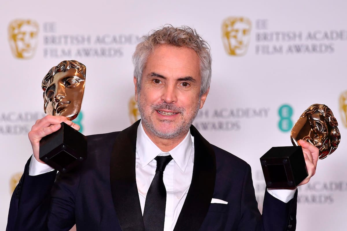 Mexican director Alfonso Cuaron poses with the awards for a Director and for Best Film for Roma at the BAFTA British Academy Film Awards at the Royal Albert Hall in London on February 10, 2019 (Photo by Ben STANSALL / AFP