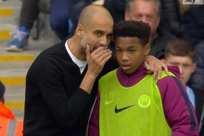 Micah Hamilton, como alcanza pelotas, junto a Pep Guardiola, en un duelo entre Manchester City y Crystal Palace, por la Premier League, en 2017