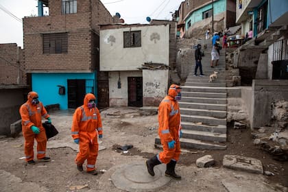 Trabajadores de la salud recorren las calles de un sector vulnerable de Lima