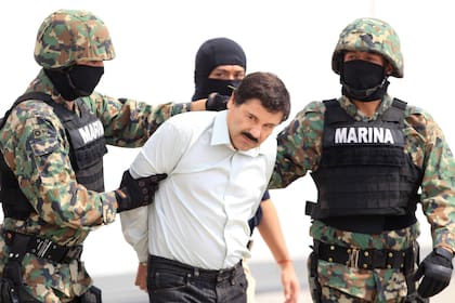 Militares mexicanos conducen al máximo dirigente del cártel de Sinaloa, Joaquín "El Chapo" Guzmán, detenido esa madrugada en el puerto turístico de Mazatlá, en 2014