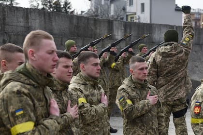 Militares ucranianos asisten a los funerales de tres compañeros de armas caídos a manos de fuerzas rusas, en el cementerio de Lychakiv de la ciudad de Lviv
