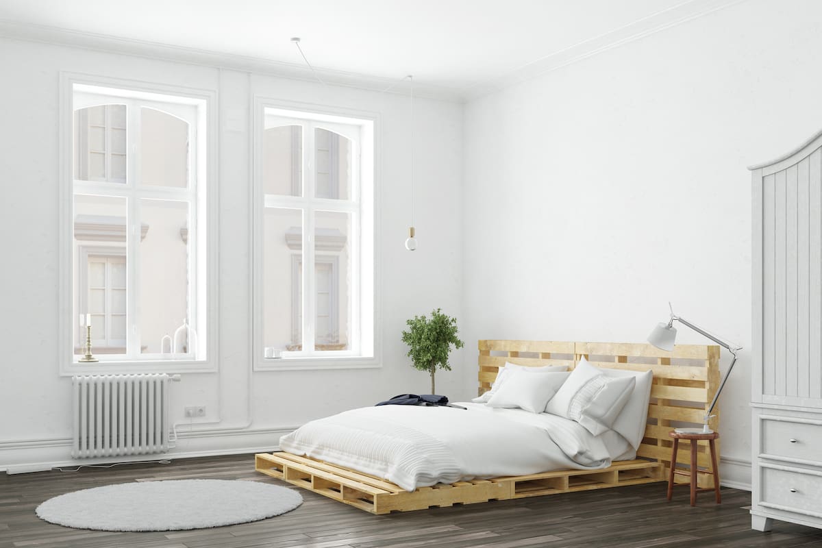 Minimalistic bedroom with palette bed and white furniture (3D Rendering)