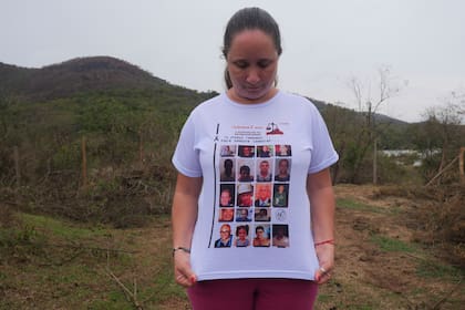 Monica dos Santos, de 39 años, lleva una camiseta con las fotos de las víctimas de la rotura de una presa en Bento Rodrigues, estado de Minas Gerais, Brasil, el 19 de octubre de 2024. (AP Foto/Eleonore Hughes)