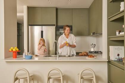 Mueble de cocina en melamina ‘Safari’ (Faplac), diseñado a medida por el Estudio. Mesadas blancas de Silestone.