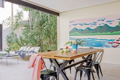 Mural realizado por Michel Fassi (Eileen Vergez, asesoramiento de arte). Mesa de lapacho (Estudio Losa) rodeada de sillas ‘Tólix’.