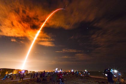 Gran cantidad de personas en la playa de Cabo Cañaveral, Florida, observan el lanzamiento del SpaceX Falcon 9 Crew Dragon en su misión Crew-1 con cuatro astronautas