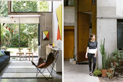 Natalia frente a su puerta, hecha de 3m de alto para entrar obras de gran formato. El volumen de concreto y vidrio que avanza sobre el living y las diagonales identifican la arquitectura del edificio.