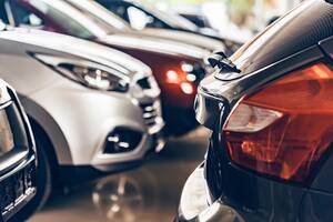 New cars at dealer showroom blurred background