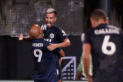 New York City FC midfielder Maximiliano Moralez is hoisted up by forward Heber (9) after scoring a goal during the second half of an MLS soccer match against Toronto FC, Sunday, July 26, 2020, in Kissimmee, Fla