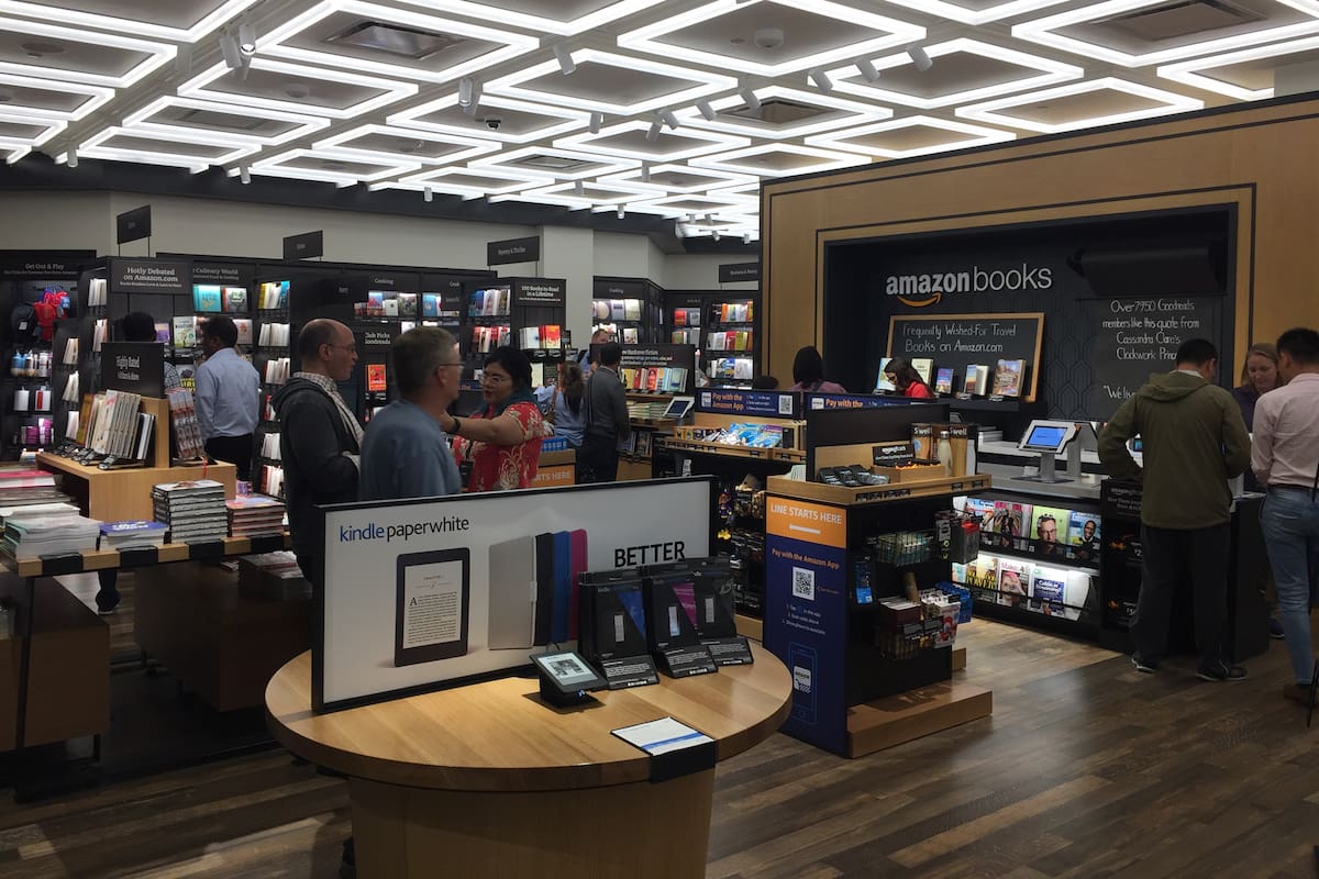 NEW YORK- JULY 2017: Amazon Books store clerk behind counter. Customers can pay w Amazon Prime in brick-and-mortar Time Warner Center. E-commerce biz sells Kindles, Fire TV tablet Alexa Echo AMZN