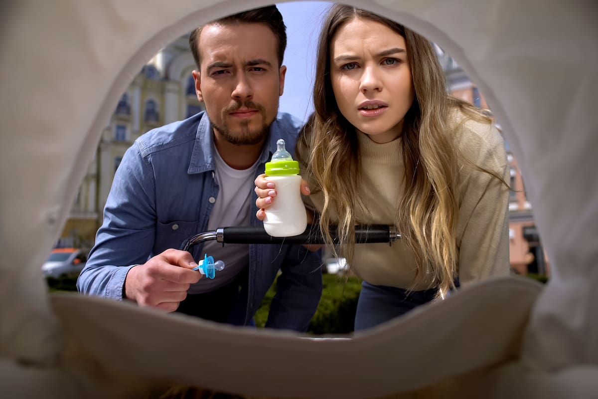 Newborn pov looking at irritated mother and father with bottle of milk, family