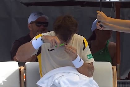 Nunca visto: el tenista porteño Camilo Ugo Carabelli se corta el pelo durante un descanso, en el torneo de Auckland