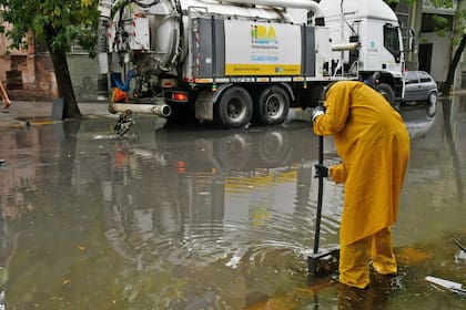 Operarios de la ciudad trabajan para destapar los sumideros y procurar que el agua se escurra de las calles
