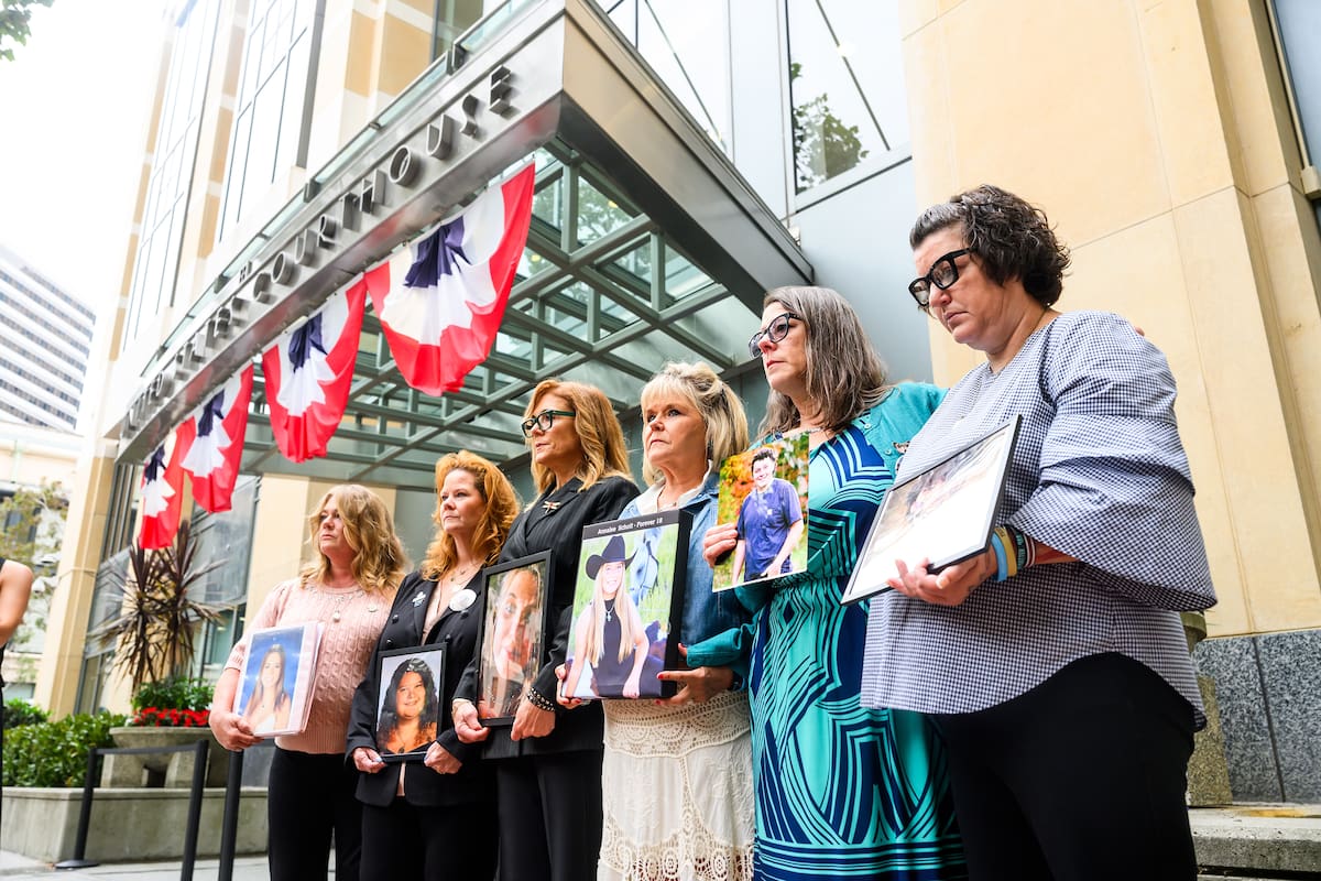 Padres de familia sostienen fotografías de sus hijos fallecidos durante una protesta contra las plat