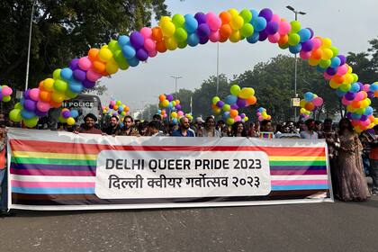 Participantes del Desfile del Orgullo en Delhi marchan con una bandera en Nueva Delhi, India, el domingo 26 de noviembre de 2023. El acto anual se celebraba después de que la máxima corte del país se negarra a legaliza el matrimonio igualitario en un fallo en octubre. (AP Foto/Shonal Ganguly)