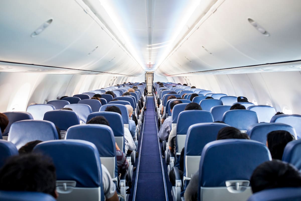 Passengers traveling by a plane, shot from the inside of an airplane