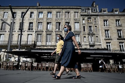 Peatones con mascarillas debido a la pademia de coronavirus caminan en Burdeos, suroeste de Francia, el 14 de septiembre de 2020