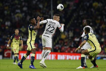Pedro Aquino (izquierda), del América, presiona a Franco Troyansky (22), del Atlas, en busca de un balón durante un partido de la Liga MX, disputado el sábado 22 de enero de 2022, en el Estadio Azteca (AP Foto/Ginnette Riquelme)