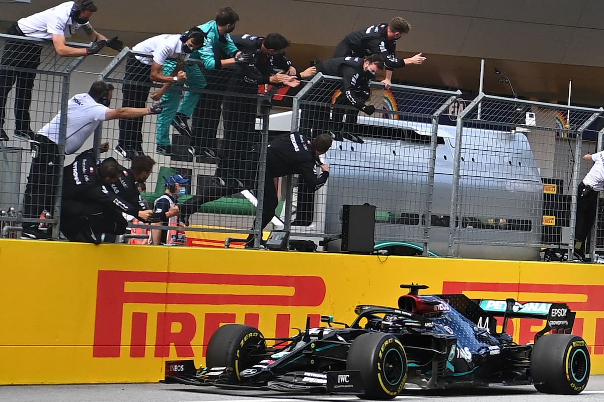 People take pictures as Mercedes British driver Lewis Hamilton wins the Formula One Styrian Grand Prix race on July 12, 2020 in Spielberg, Austria. (Photo by Joe Klamar / various sources / AFP)