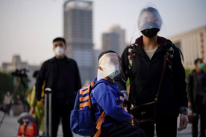 People wait for the train at the Hankou Railway Station in Wuhan as travel restrictions for leaving the city, the epicentre of a global coronavirus disease (COVID-19) outbreak, are lifted and people will be allowed to leave the city via road, rail and air, in Wuhan, Hubei, China April 8, 2020. REUTERS/Aly Song