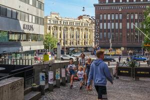 People walking on the street in front of Stockmann shopping centre are seen in Helsinki, Finland on 1 August 2022 (Photo by Michal Fludra/NurPhoto via Getty Images)