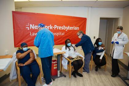 Personal médico inyectando una segunda dosis de la vacuna de Pfizer en el Hospital NewYork-Presbyterian Lawrence, en Bronxville, Nueva York. (AP Foto/Kevin Hagen, Archivo)