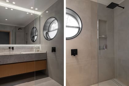 Piso y revestimiento de paredes en baldosas ‘Matières’ de Florim. Mesada con bacha integrada de mármol ‘Tundra Grey’. Grifería Hansgrohe (Folk Designer). Reemplazaron la bañadera por un box de ducha e hicieron un nuevo revestimiento de chapa para la ventana circular que da a la calle.