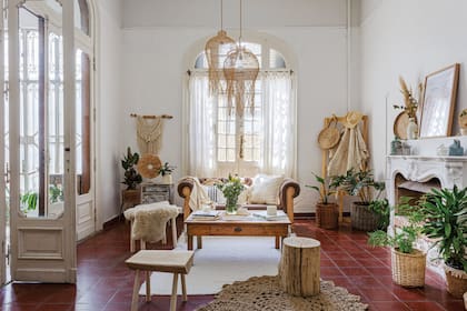Plantas de interior y velas (El Mercadito de Maio). Bancos de álamo y cestos de mimbre (DecoBrooklyn). Mesa baja y mesita de luz restauradas, alfombra de yute y tapices en macramé (todo de Casa Pastel).