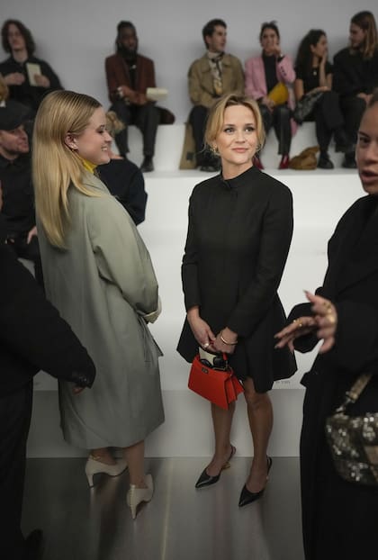 Reese Witherspoon optó por un vestido negro corto de manga larga y cuello perkins, zapatos de taco alto y un bolso en tono coral. Ava Phillippe, en cambio, optó por unas bermudas, un sweater cuello tortuga amarillo y un saco gris. En la mano llevó un bolso similar al de su mamá, pero de otro color