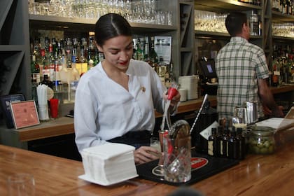 Rep. Alexandria Ocasio-Cortez, D-N.Y., mixes margaritas while tending bar at a restaurant in the Queens borough of New York, Friday, May 31, 2019. She was back in her New York district tending bar as part of her push to raise the federal minimum wage, especially for workers who now depend on tips. (