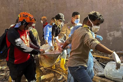 Rescatistas trasladan el cuerpo de una persona afectada por la tormenta en Derna