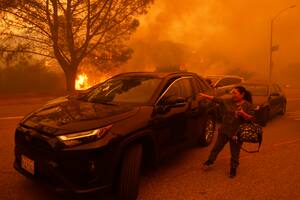 Residentes de Los Ángeles huyen ante el avance de incendio avivado por el viento