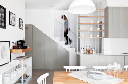 Antes, la cocina estaba debajo de la escalera, donde hoy está el mueble de guardado de artículos de limpieza. Sobre los estantes, macetas de cerámica (Coto).