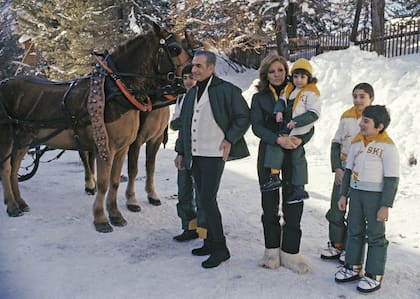 From left to right: Reza Pahlavi II, the Crown Prince, their father, the Shah of Iran Mohammed Reza Shah Pahlavi, his wife and mother HIM Farah Pahlavi Empress (or Shahbanu) of Iran, holding their youngest daughter, Leila Pahlavi, Farahnaz Pahlavi and Aly Reza Pahlavi embark on a sleigh ride during a winter vacation, February 25, 1975, in Saint-Moritz, Switzerland. . (Photo by James Andanson/Sygma via Getty Images)