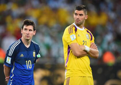 RIO DE JANEIRO, BRAZIL - JULY 13: A dejected Lionel Messi (L) and Mariano Andujar of Argentina look on after being defeated by Germany 1-0 in extra time during the 2014 FIFA World Cup Brazil Final match between Germany and Argentina at Maracana on July 13, 2014 in Rio de Janeiro, Brazil. (Photo by Jamie McDonald/Getty Images)