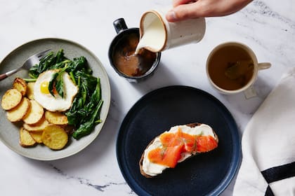 Roasted potato slices on a bed of spinach, topped with an egg, and whole-grain toast with cream cheese and lox in New York, April 18, 2023. The ideal breakfast is the one that makes you feel your best, experts say, though there are some important nutrients to keep in mind. (Bobbi Lin/The New York Times)