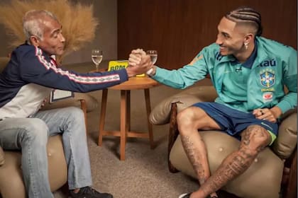 Romario saluda a Raphinha, en medio de una entrevista que tras el 1-4 ante la Argentina todos critican en Brasil