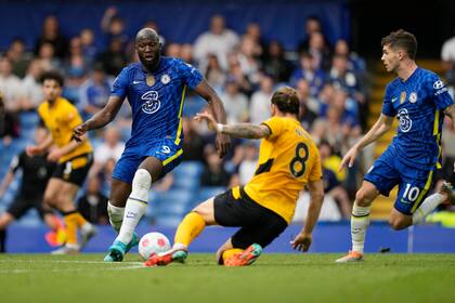 Romelu Lukaku del Chelsea driblea el balón intentando superar a Ruben Neves del Wolverhampton en el encuentro de la Liga Premier del sábado 7 de mayo del 2022. (AP Foto/Frank Augstein)