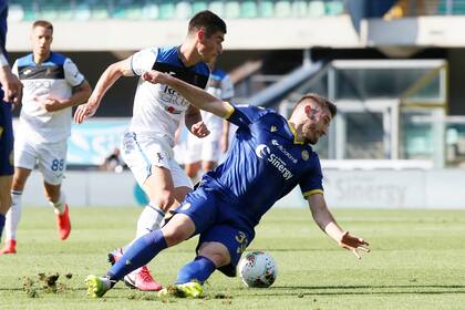 Ruslan Malinovskyi de Atalanta y el brasileño Allan Empereur de Verona pelean por la pelota durante el partido de la fecha 34 de la liga italiana disputado hoy en el estadio Marco Antonio Bentegodi, de Verona.