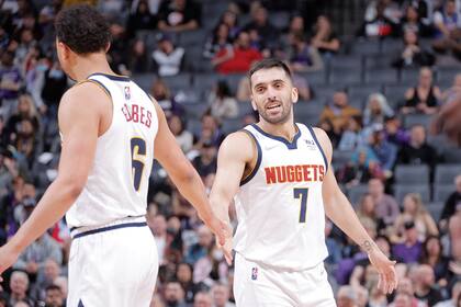 SACRAMENTO, CA - MARCH 9: Bryn Forbes #6 hi-fives Facundo Campazzo #7 of the Denver Nuggets during the game against the Sacramento Kings on March 9, 2022 at Golden 1 Center in Sacramento, California. NOTE TO USER: User expressly acknowledges and agrees that, by downloading and or using this Photograph, user is consenting to the terms and conditions of the Getty Images License Agreement. Mandatory Copyright Notice: Copyright 2022 NBAE Rocky Widner/NBAE via Getty Images/AFP (Photo by ROCKY WIDNER / NBAE / Getty Images / Getty Images via AFP)