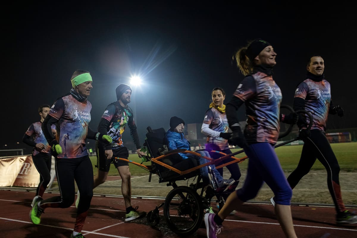 Sammy Basso, center, trains with his runners club, a group of friends and fans who run marathons to support awareness of his disease of progeria, in Bassano del Grappa, Italy, March 10, 2022. Basso, 26, is believed to be the oldest surviving person with Hutchinson-Gilford Progeria syndrome, and with his degrees in natural science and molecular biology is helping with research efforts to discover a treatment and the secrets of aging. (Nadia Shira Cohen/The New York Times)