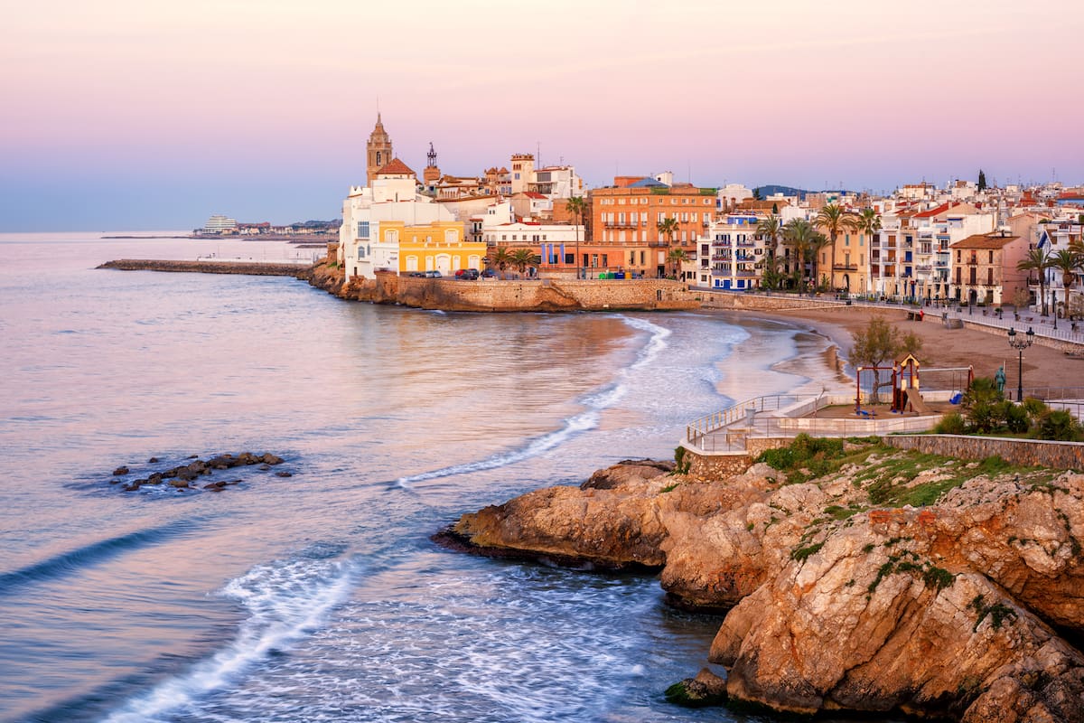 Sand beach and historical Old Town in mediterranean resort Sitges near Barcelona, Costa Dorada, Catalonia, Spain