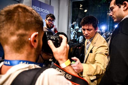 Santiago Caputo fotografía la credencial de Antonio Becerra, fotoperiodista de Tiempo Argentino en la entrada al debate porteño