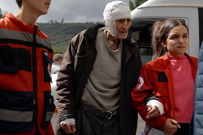 Sasha, un hombre de etnia armenia que tiene 84 años y está herido, recibe ayuda de voluntarios a su llegada desde Stepanakert, en Nagorno Karabaj, a Goris, en la región armenia de Syunik, el miércoles 27 de septiembre de 2023. (AP Foto/Vasily Krestyaninov)