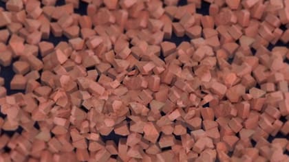 Se trata de una pastilla de forma triangular, de color rojo, amarillo o naranja con una S en el centro