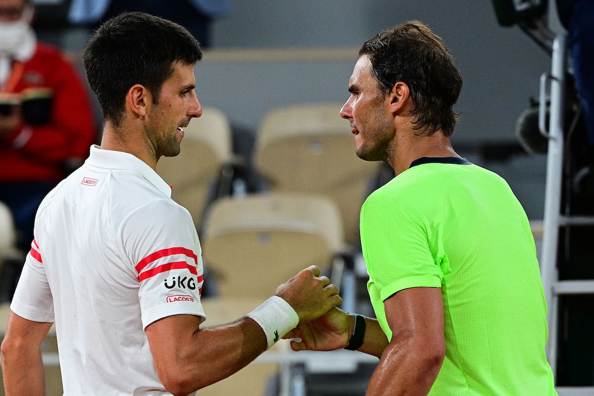 Serbia's Novak Djokovic (L) and Spain's Rafael Nadal shake hands at the end of their men's singles semi-final tennis match on Day 13 of The Roland Garros 2021 French Open tennis tournament in Paris on June 11, 2021. (Photo by MARTIN BUREAU / AFP)