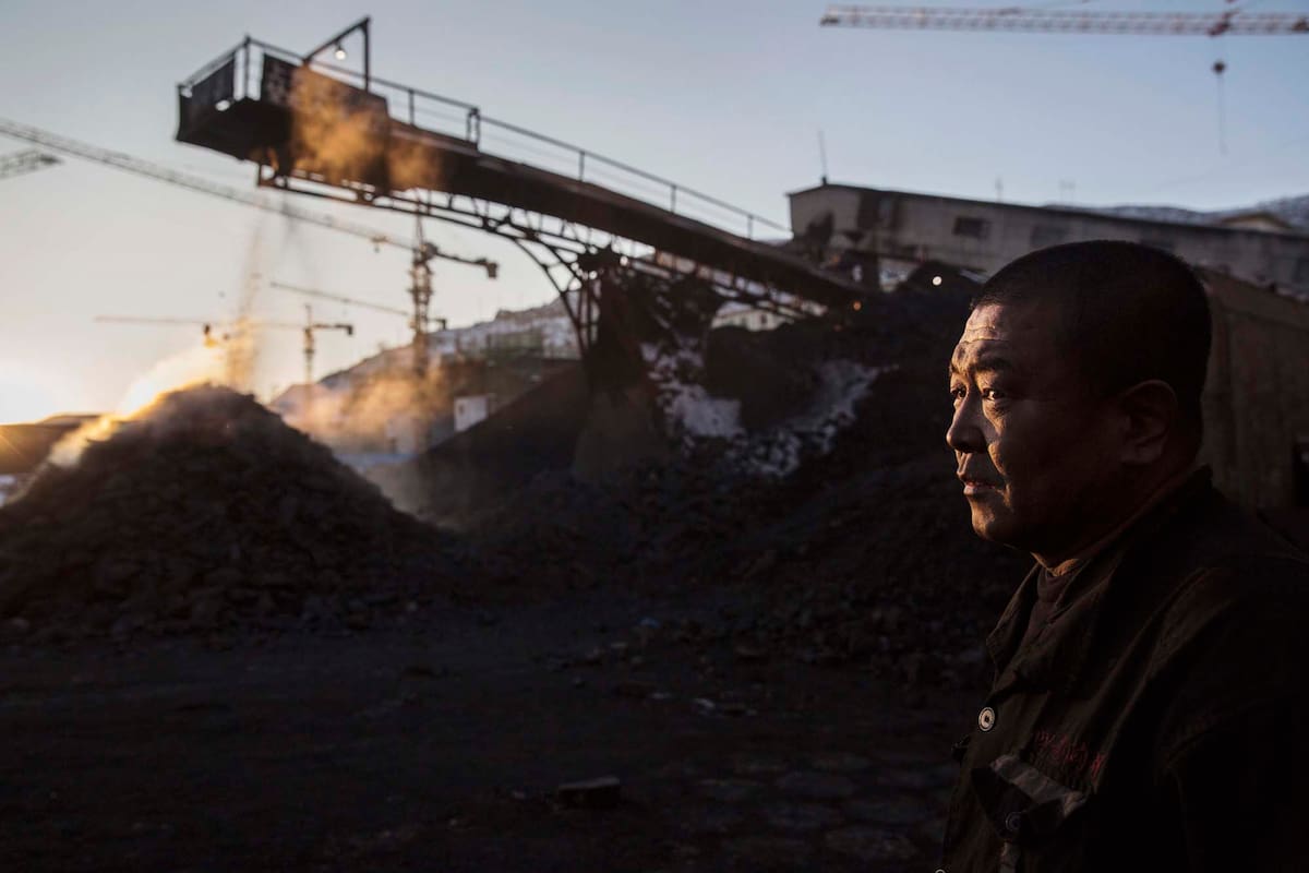 SHANXI, CHINA -NOVEMBER 25: (CHINA, HONG KONG, MACAU, TAIWAN OUT) A Chinese mine worker looks on as coal is moved on a conveyor belt in a sorting area at a coal mine on November 25, 2015 in Shanxi, China. A history of heavy dependence on burning coal for energy has made China the source of nearly a third of the world's total carbon dioxide (CO2) emissions, the toxic pollutants widely cited by scientists and environmentalists as the primary cause of global warming. China's government has publicly set 2030 as a deadline to reach the country's emissions peak, and data suggest the country's coal consumption is already in decline. (Photo by Kevin Frayer/Getty Images)