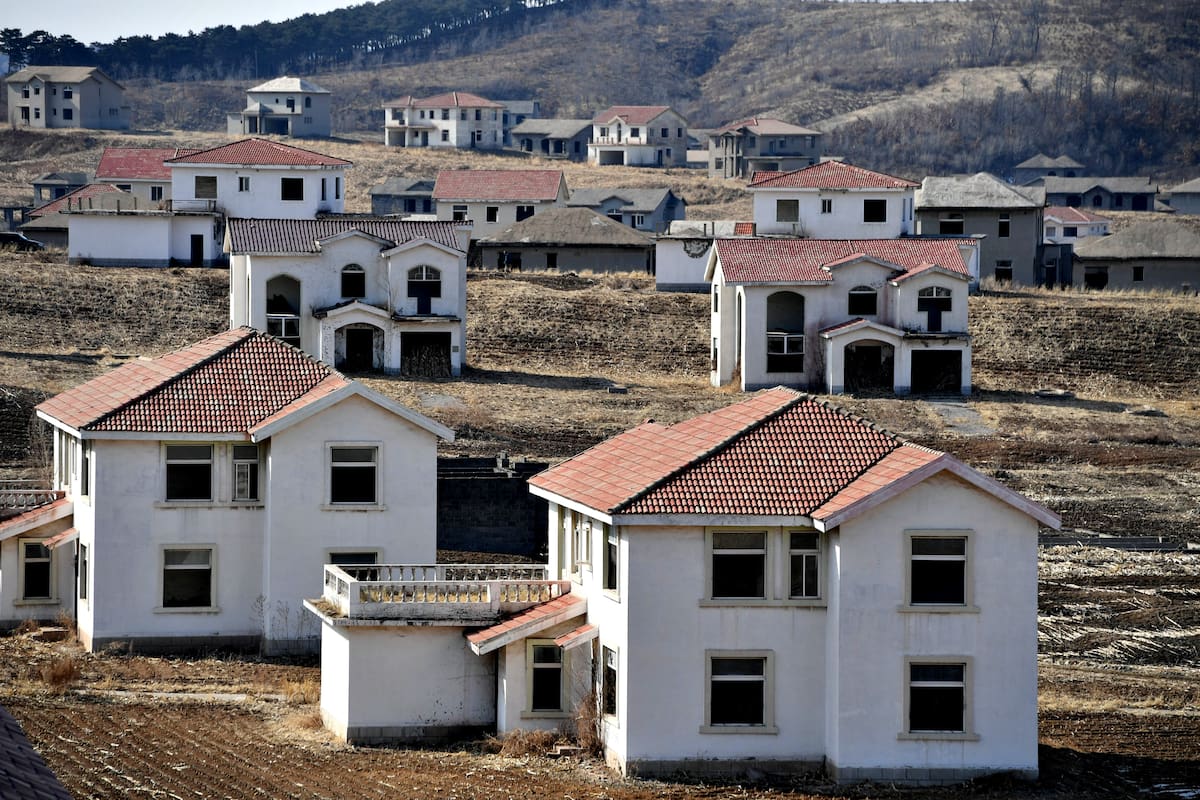 SHENYANG, CHINA - FEBRUARY 24 2021: A view of unfinished villa buildings in a real estate project deserted for over two decades in Shenyang in northeast China's Liaoning province Wednesday, Feb. 24, 2021. Over 300 concrete houses are littered on the unattended land.- PHOTOGRAPH BY Feature China / Future Publishing (Photo credit should read Feature China/Future Publishing via Getty Images)