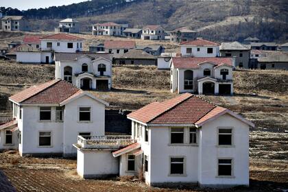 SHENYANG, CHINA - FEBRUARY 24 2021: A view of unfinished villa buildings in a real estate project deserted for over two decades in Shenyang in northeast China's Liaoning province Wednesday, Feb. 24, 2021. Over 300 concrete houses are littered on the unattended land.- PHOTOGRAPH BY Feature China / Future Publishing (Photo credit should read Feature China/Future Publishing via Getty Images)